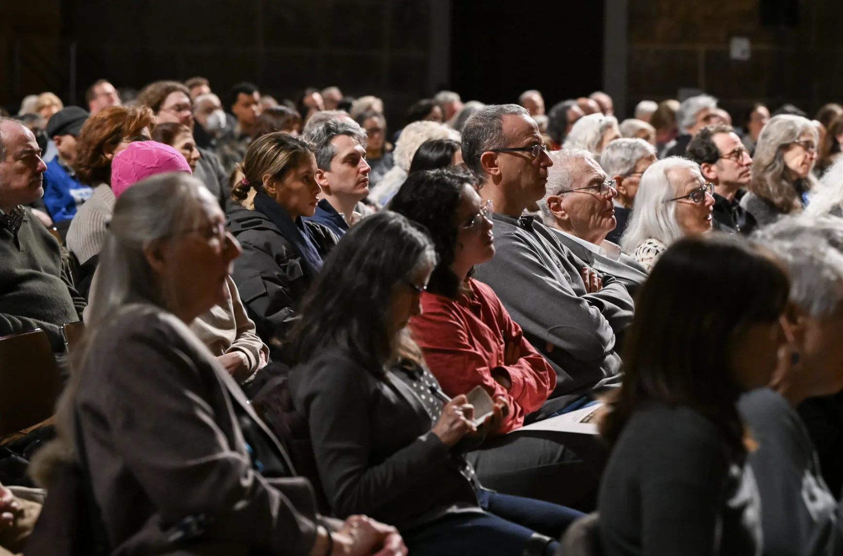 Audience members listen to panelists during event