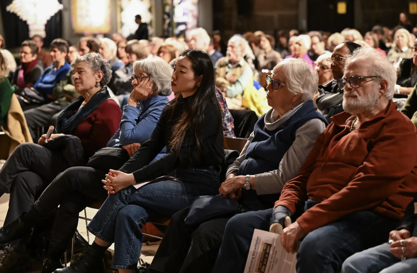 Audience members look toward stage during panel