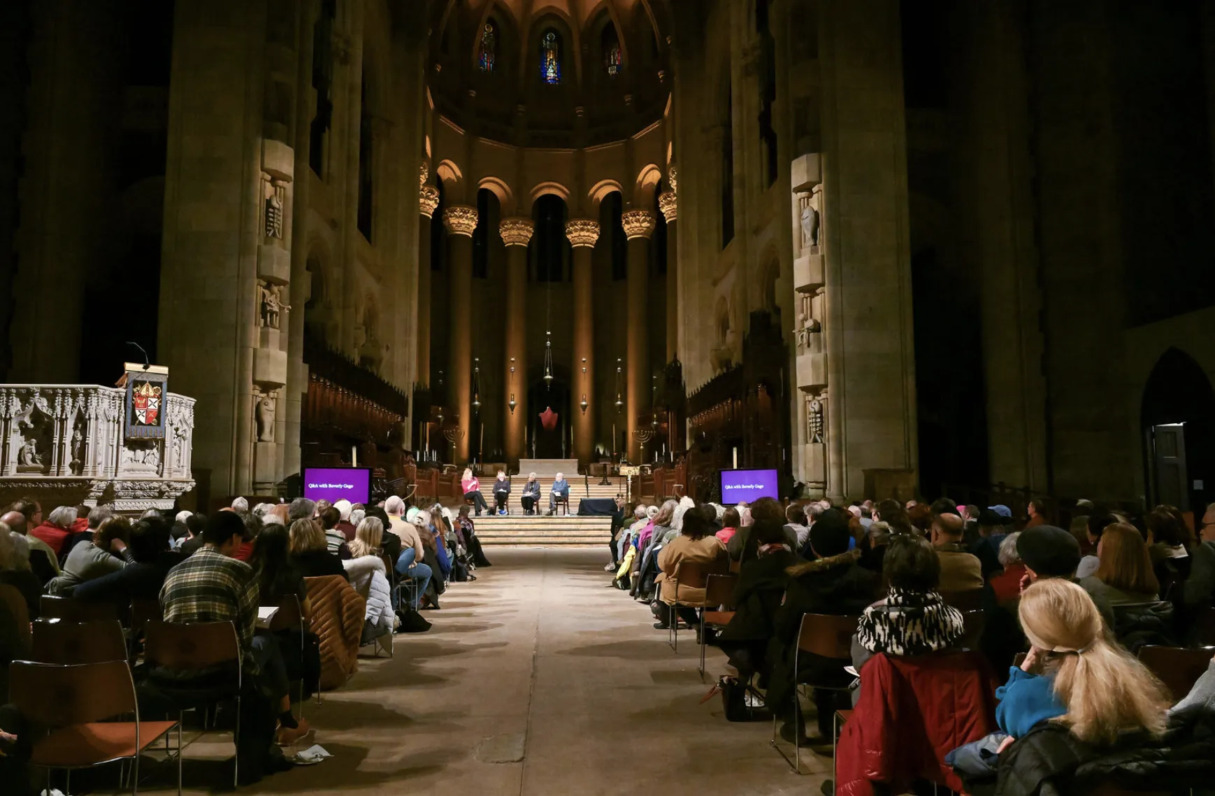 Entire audience in church with panelists at the front